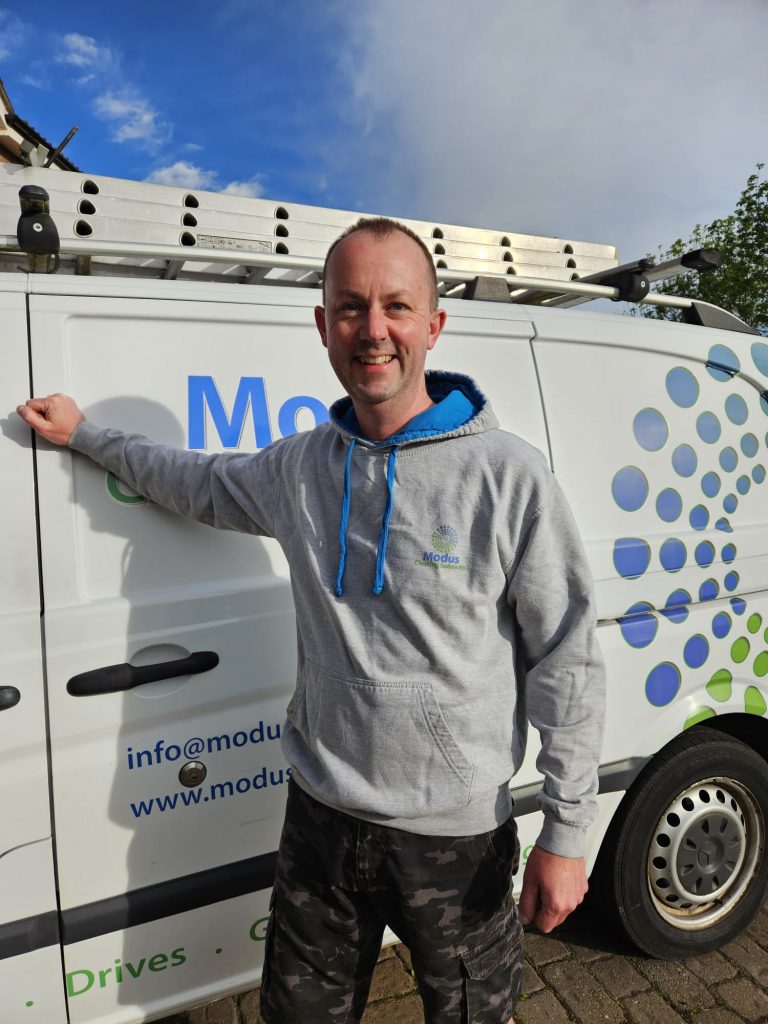 image of the owner of Modus standing next to van